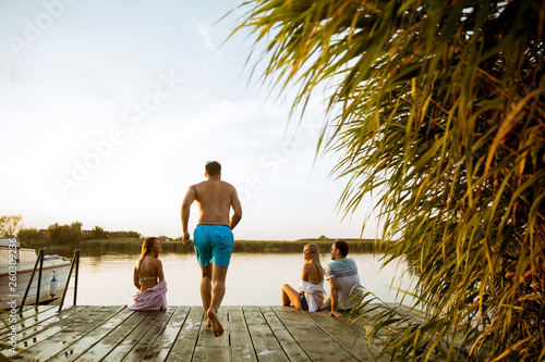 Young people having fun at the lake on a summer day