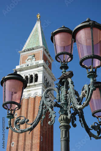 a tower and a street lamp of venice on a sunny day