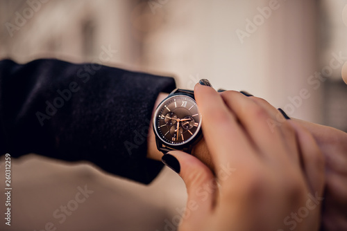 Stylish black watch on woman hand