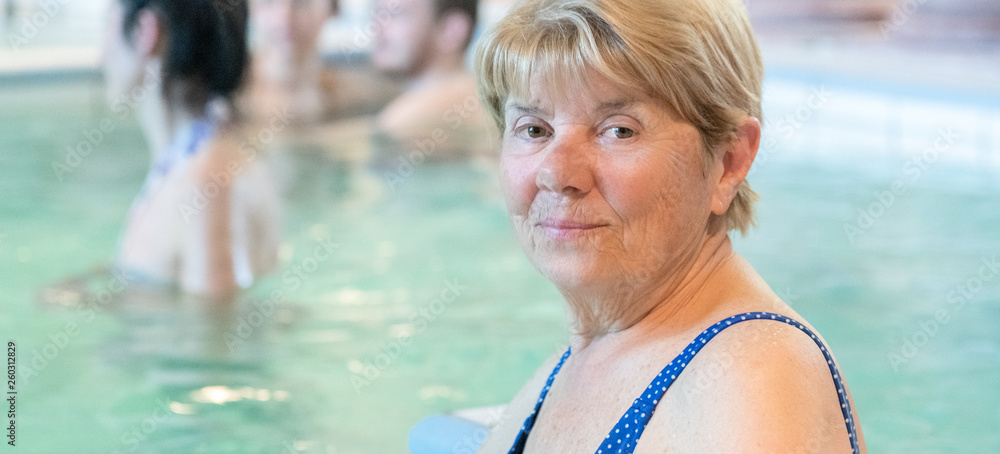 Fototapeta premium Mature retired woman enjoying thermal baths. Heathcare and happiness concepts. Leisure activity