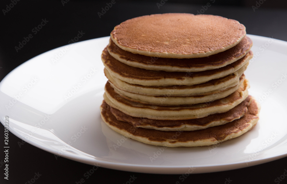 Delicious warm morning pancakes on a white plate Delicious warm morning pancakes on a white plate