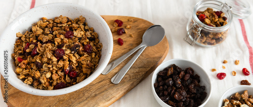 Dry breakfast cereals. Crunchy honey granola bowl with flax seeds, cranberries and coconut. Healthy, vegeterian fiber food. Breakfast time. Dieting concept for banner