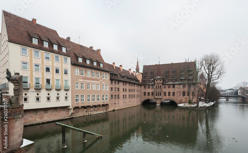 Heilig-Geist-Spital (Hospice of the Holy Spirit) in Old Town Nuremberg. View from the Museum Bridge on the on the River Pegnitz - Nuremberg, Bavaria - Germany photo