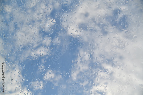 water drops on the glass against the background of clouds