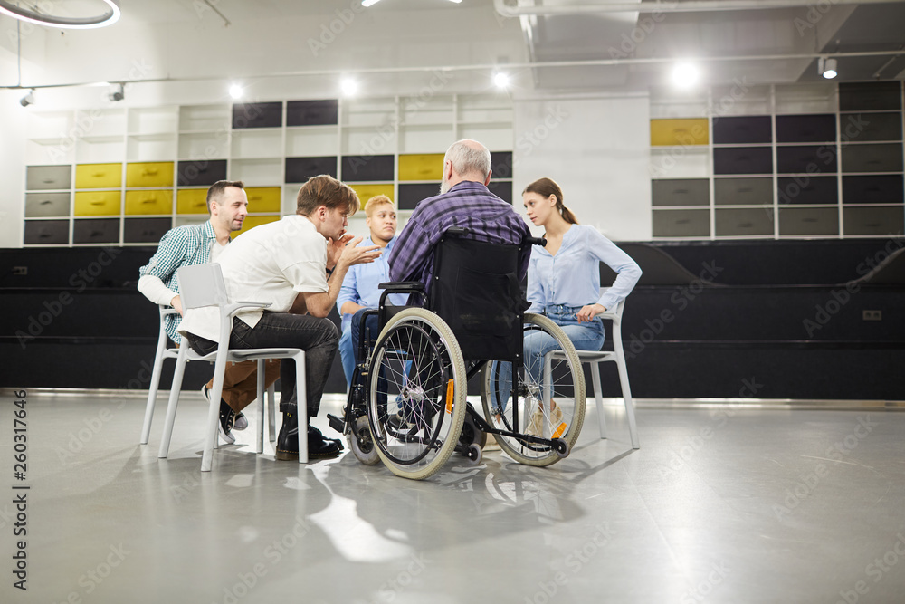 Back view portrait of handicapped man sharing troubles with support group during therapy session, copy space Back view portrait of handicapped man sharing troubles with support group during therapy session, copy space