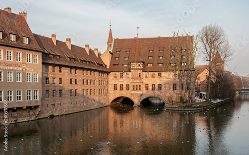 Heilig-Geist-Spital (Hospice of the Holy Spirit) in Old Town Nuremberg. View from the Museum Bridge on the on the River Pegnitz - Nuremberg, Bavaria - Germany photo