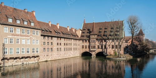 Heilig-Geist-Spital (Hospice of the Holy Spirit) in Old Town Nuremberg. View from the Museum Bridge on the on the River Pegnitz - Nuremberg, Bavaria - Germany photo