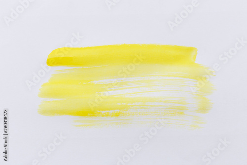 Yellow paint brush color on white paper background.
