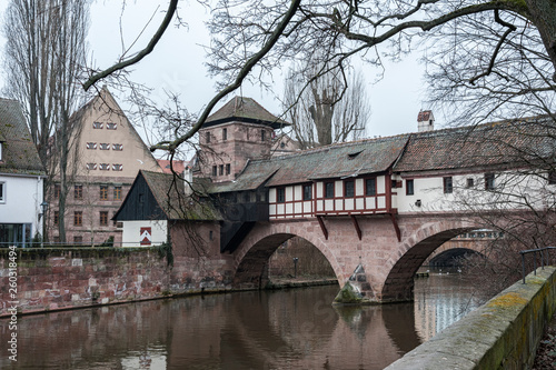 The famous Weinstadl and Wasserturm (Water Tower) over the river Pegnitz and  Henkersteg and Henkerhaus  seen from Maxbrücke - Nuremberg, Germany  photo