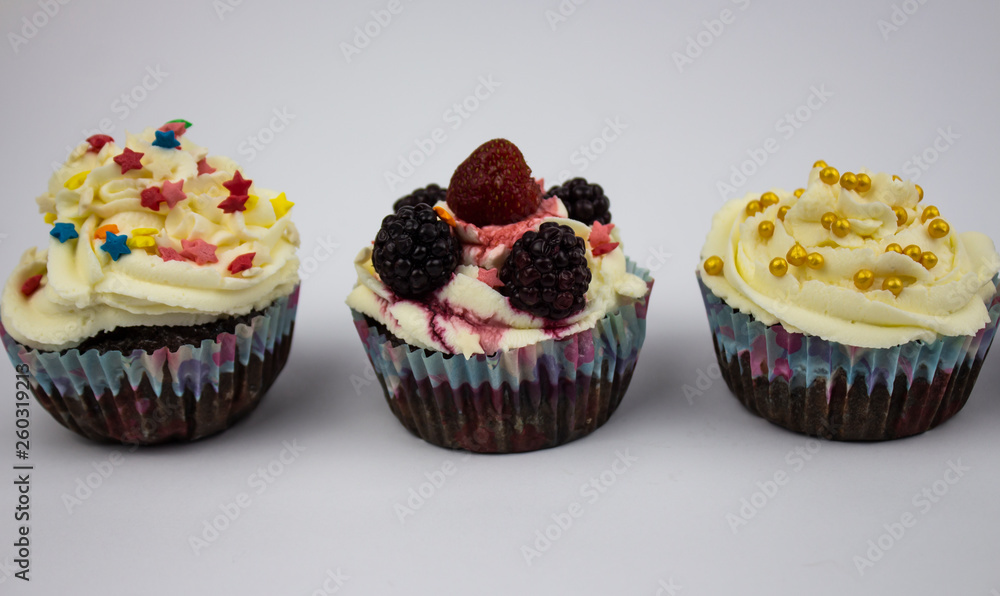 Various Cupcakes with cream on a white background. Copy space Various Cupcakes with cream on a white background. Copy space