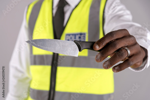 Salisbury, Wiltshire, UK. April 2019. Police officer holding a siezed kitchen knife