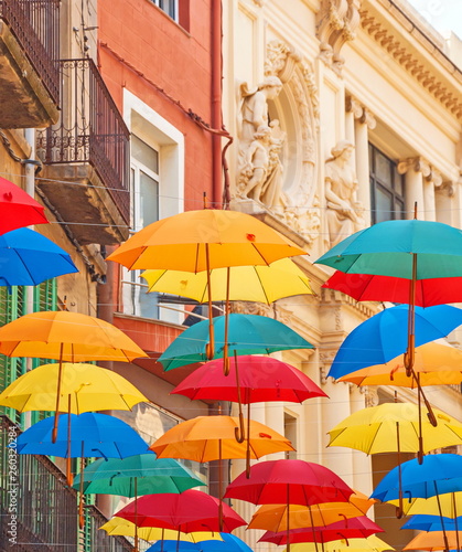 Bright colored umbrellas over  street of  Spanish city of Reus © allegro60