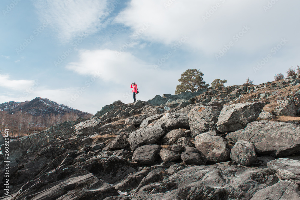 Happy woman relaxing on the top of mountain