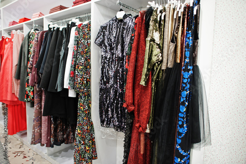Papier peint Female colorful clothing evening dresses set of on the racks in clothing store brand new modern boutique