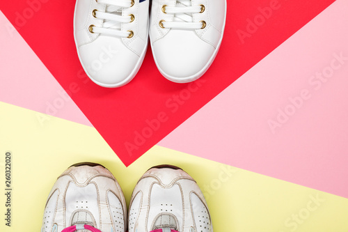 White sneakers on colorful background. Flat lay