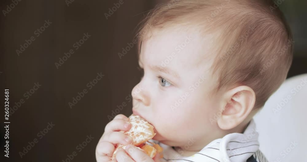 Baby boy eating mandarin Baby boy eating mandarin