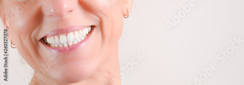 Mature woman showing perfect natural white teeth in front