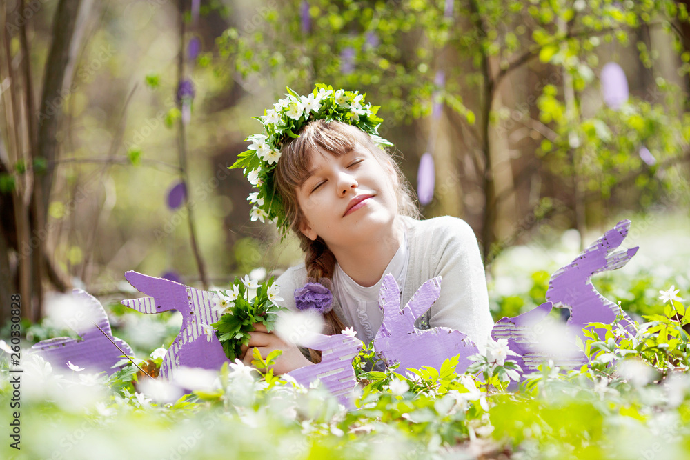 Cute teenager girl on Easter egg hunt in blooming spring garden. Children in snow drop flower meadow. Springtime in the garden Cute teenager girl on Easter egg hunt in blooming spring garden. Children in snow drop flower meadow. Springtime in the garden