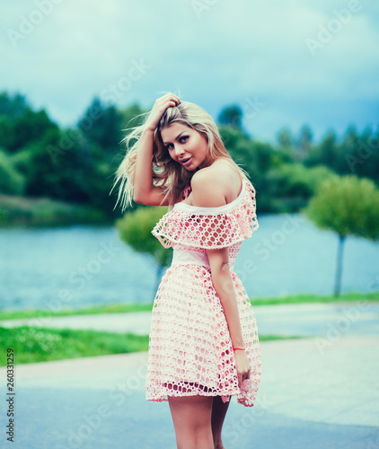 Young blonde woman in summer dress outdoors