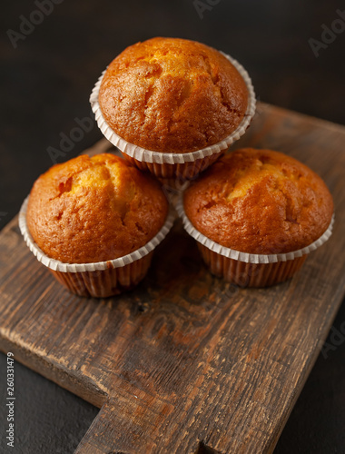 muffins with filling on a cutting board, against the background of dark concrete