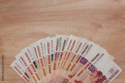 Russian money. 5000 rubles on a wooden background