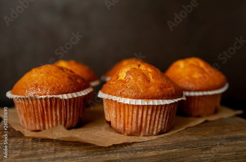 muffins with filling on a cutting board, against the background of dark concrete