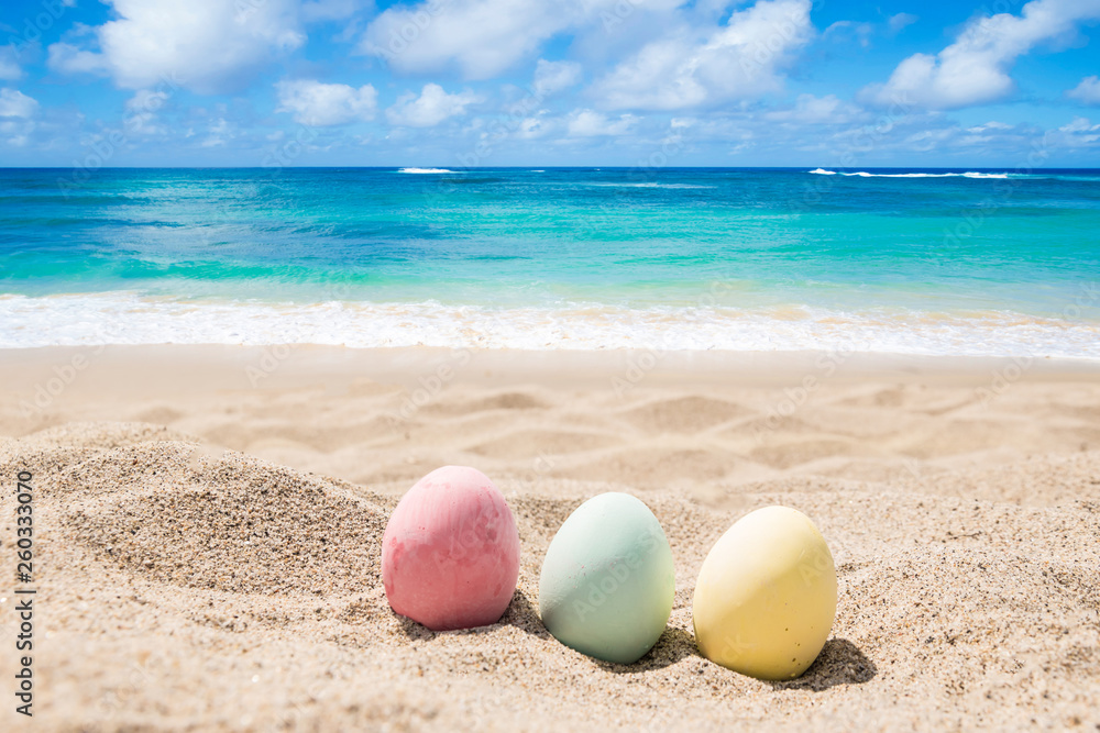 Happy easter lettering background with eggs on the sandy beach Happy easter lettering background with eggs on the sandy beach