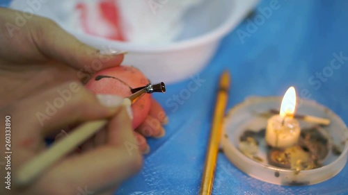 Woman painting easter eggs for holiday, easter preparation concept. cloce up photo