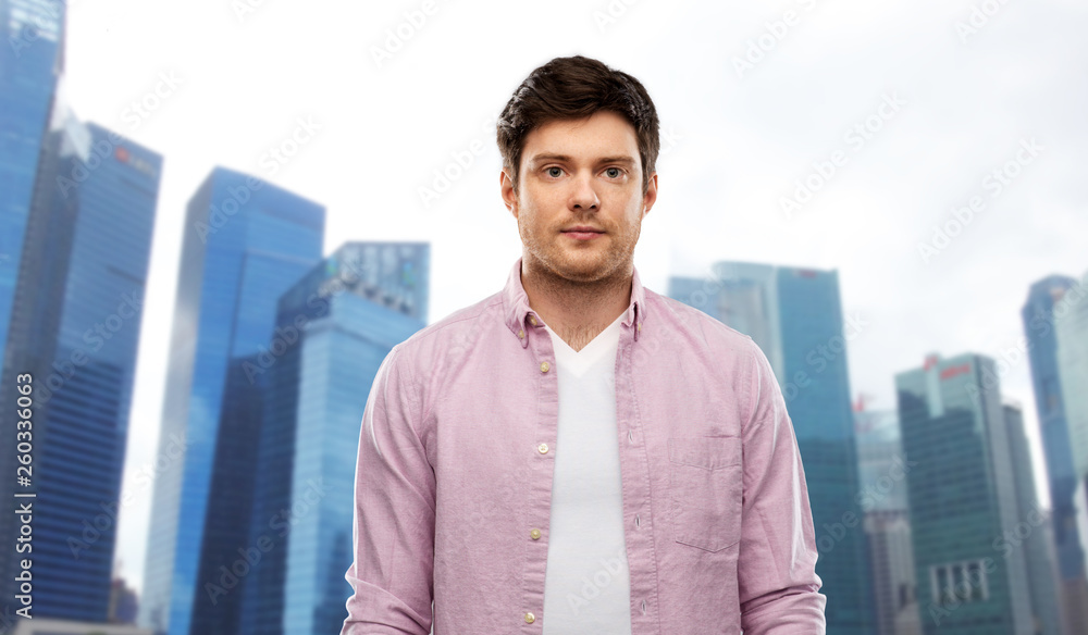 people concept - young man over singapore city skyscrapers background people concept - young man over singapore city skyscrapers background