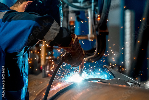 man welds at the factory