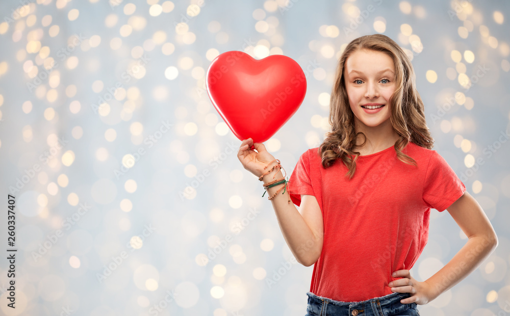 valentine's day, love and people concept - smiling pretty teenage girl with long hair in red t-shirt holding heart shaped balloon over festive lights background valentine's day, love and people concept - smiling pretty teenage girl with long hair in red t-shirt holding heart shaped balloon over festive lights background