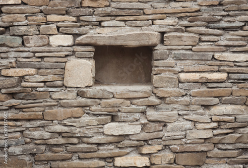 stone wall with hole for deposit in the basement