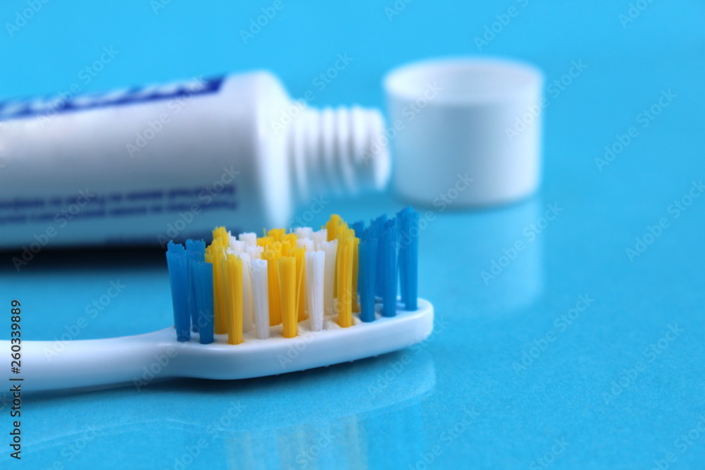 Toothpaste and toothbrush lie on a blue background Toothpaste and toothbrush lie on a blue background