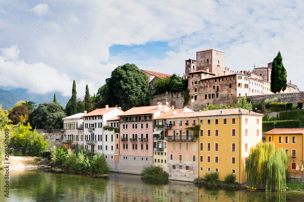 colorful houses  along river Brenta in Bassano del Grappa, Italy. With reflection in water