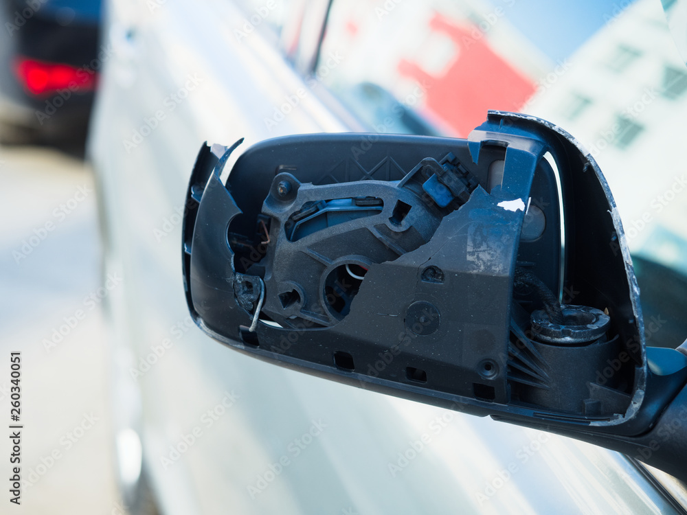 Obraz premium broken side view mirror of car. Car accident. Photo from the front.