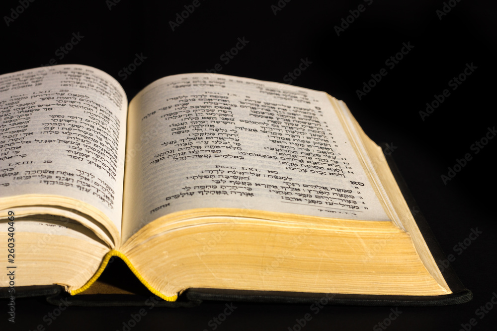 Open hebrew Bible, isolated on black background, with front lighting Open hebrew Bible, isolated on black background, with front lighting
