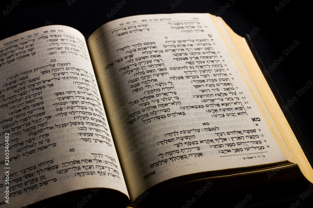 Open hebrew Bible, isolated on black background, with side lighting Open hebrew Bible, isolated on black background, with side lighting