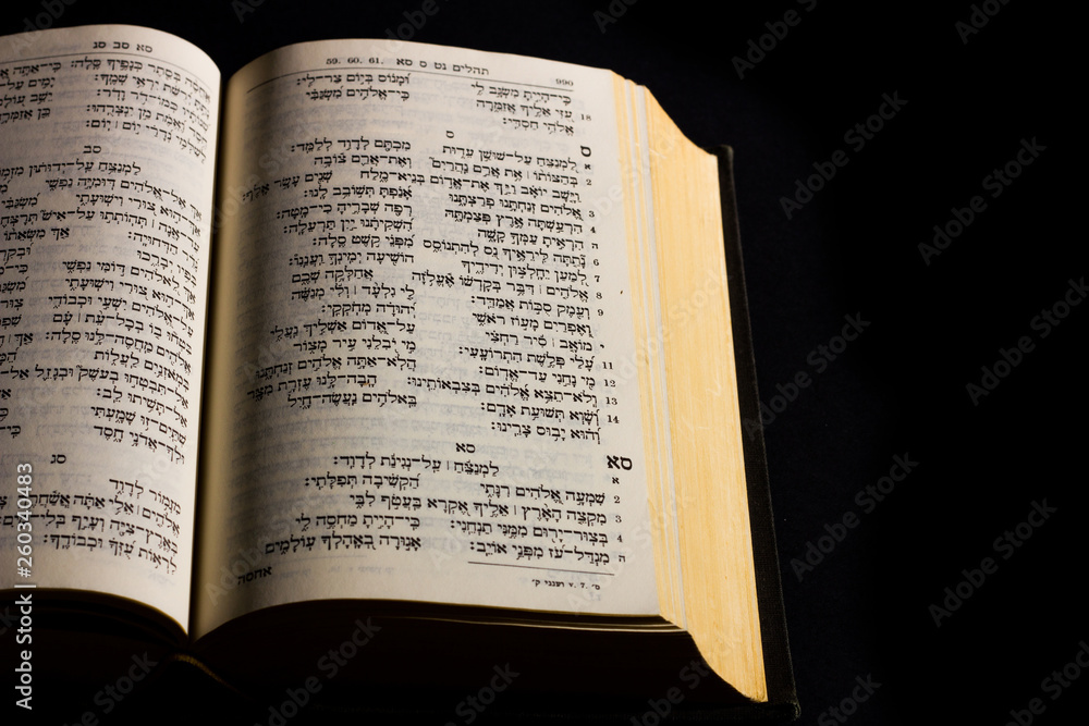 Open hebrew Bible, isolated on black background, with side lighting Open hebrew Bible, isolated on black background, with side lighting