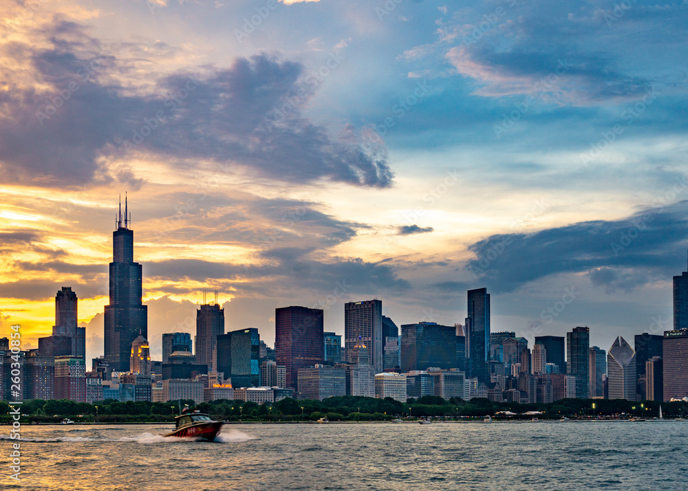 A Boat On Lake Michigan with the Chicago Skyline in the Backdrop at Sunset