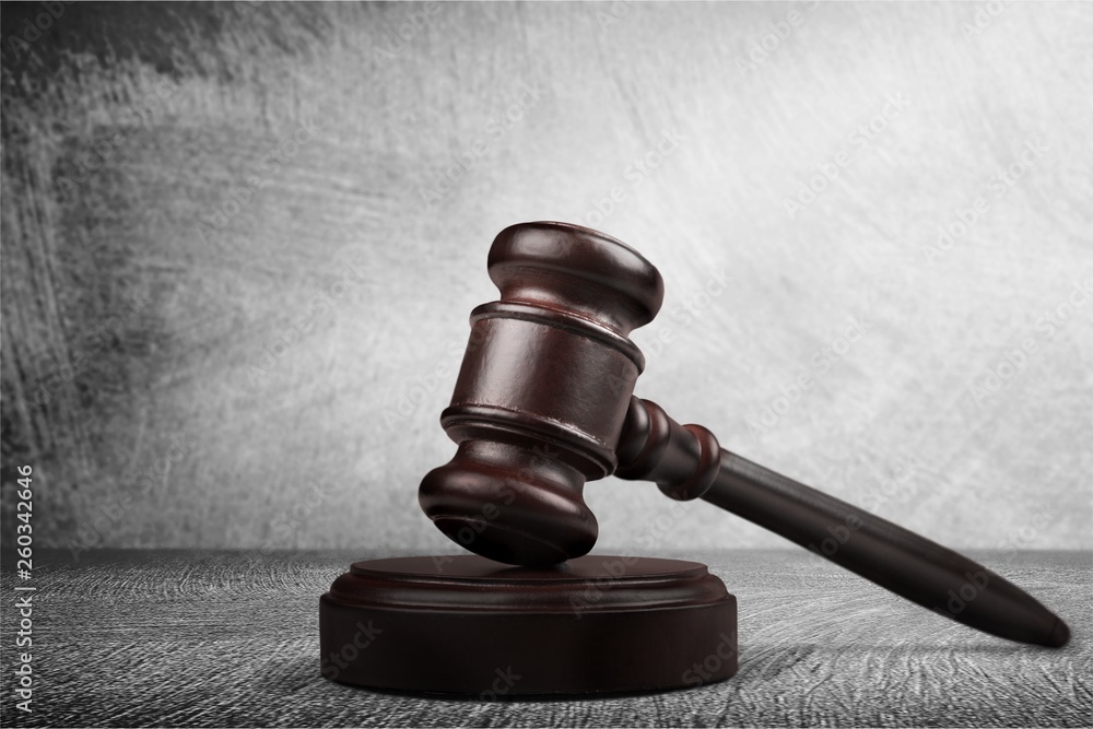 Wooden gavel on wooden table, on background Wooden gavel on wooden table, on background