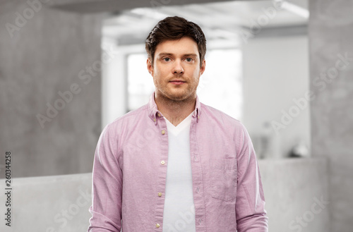 people concept - young man over concrete grey office room background