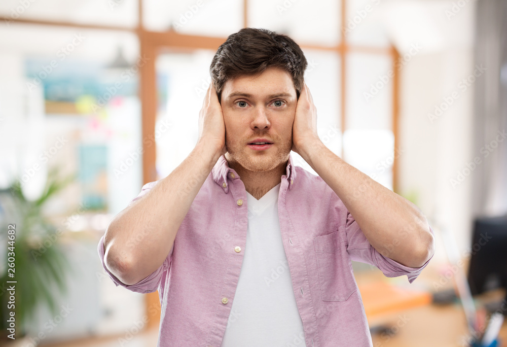 people, noise and stress concept - man closing ears by hands over ...