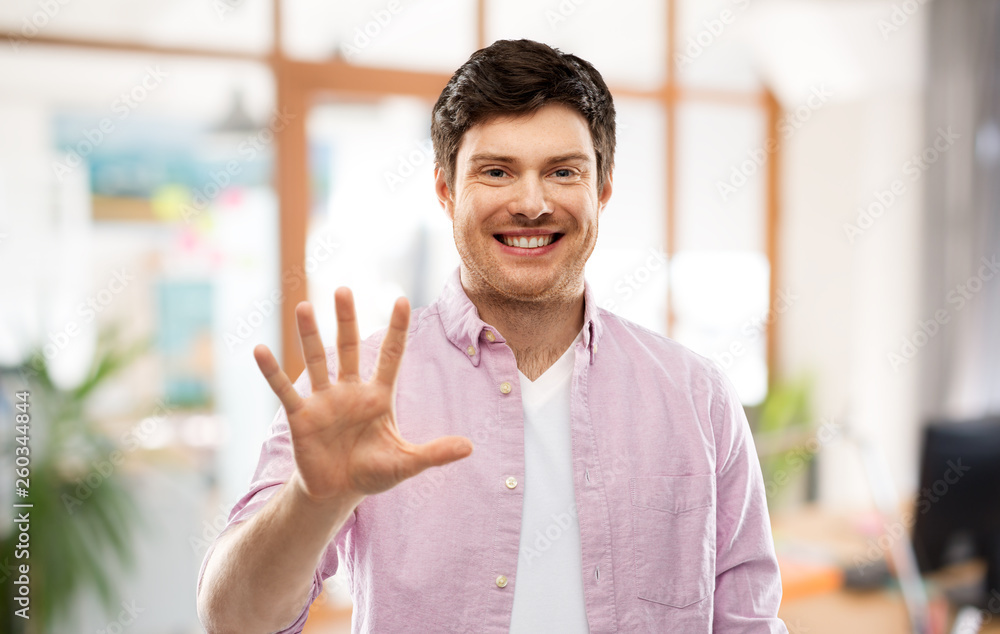 count and people concept - smiling young man showing five fingers over office room background count and people concept - smiling young man showing five fingers over office room background