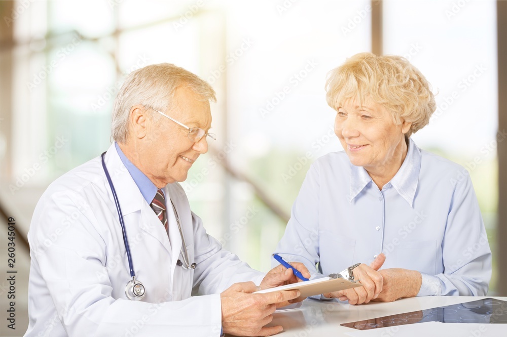 Female senior patient visiting a doctor at the medical office Female senior patient visiting a doctor at the medical office