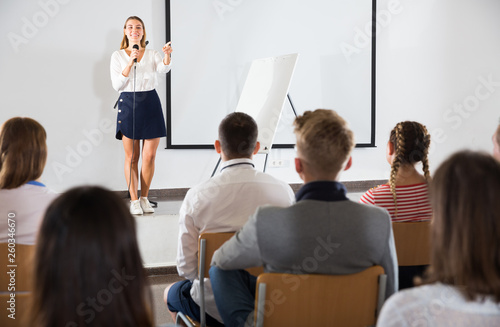 Female student answering in front of student group © JackF