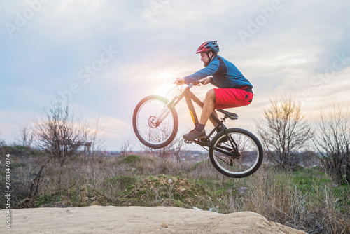 Cyclist on a mountain bike performing a jump. Active lifestyle.