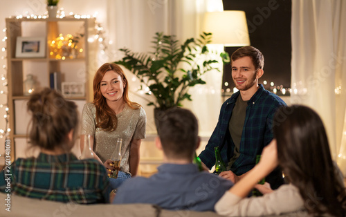 friendship, communication and people concept - group of happy friends drinking non-alcoholic beer at home © Syda Productions