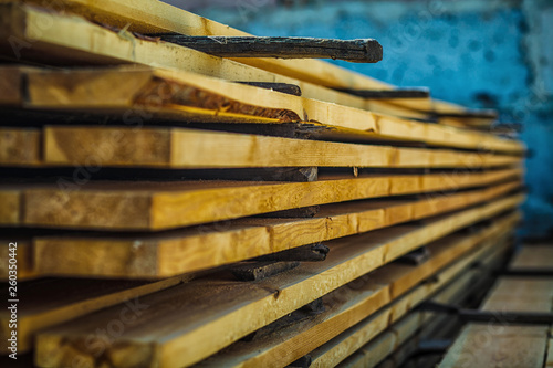 Wooden planks. Beams. Air-drying timber stack. Wood air drying (seasoning lumber or wood seasoning). Timber. Lumber. Close-up.
