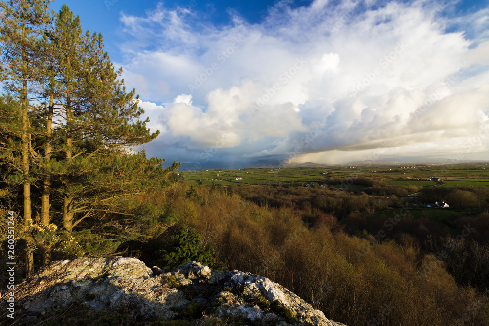 Spectacular vista overlooking the Snowdonia Mountain Range from Pentraeth Forest with storm clouds overhead Spectacular vista overlooking the Snowdonia Mountain Range from Pentraeth Forest with storm clouds overhead