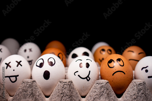 Eggs with funny expressions simulating human faces. Concept of ethnic diversity and moods.